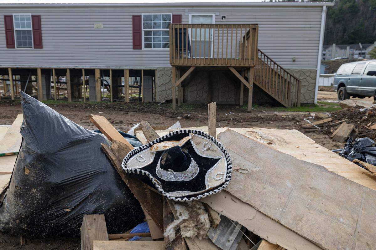 A discarded sombrero is among debris from Hurricane Helene damaged homes in a mobile home park adjacent to Winkler Creek on Wednesday, November 27, 2024 in Boone, N.C.