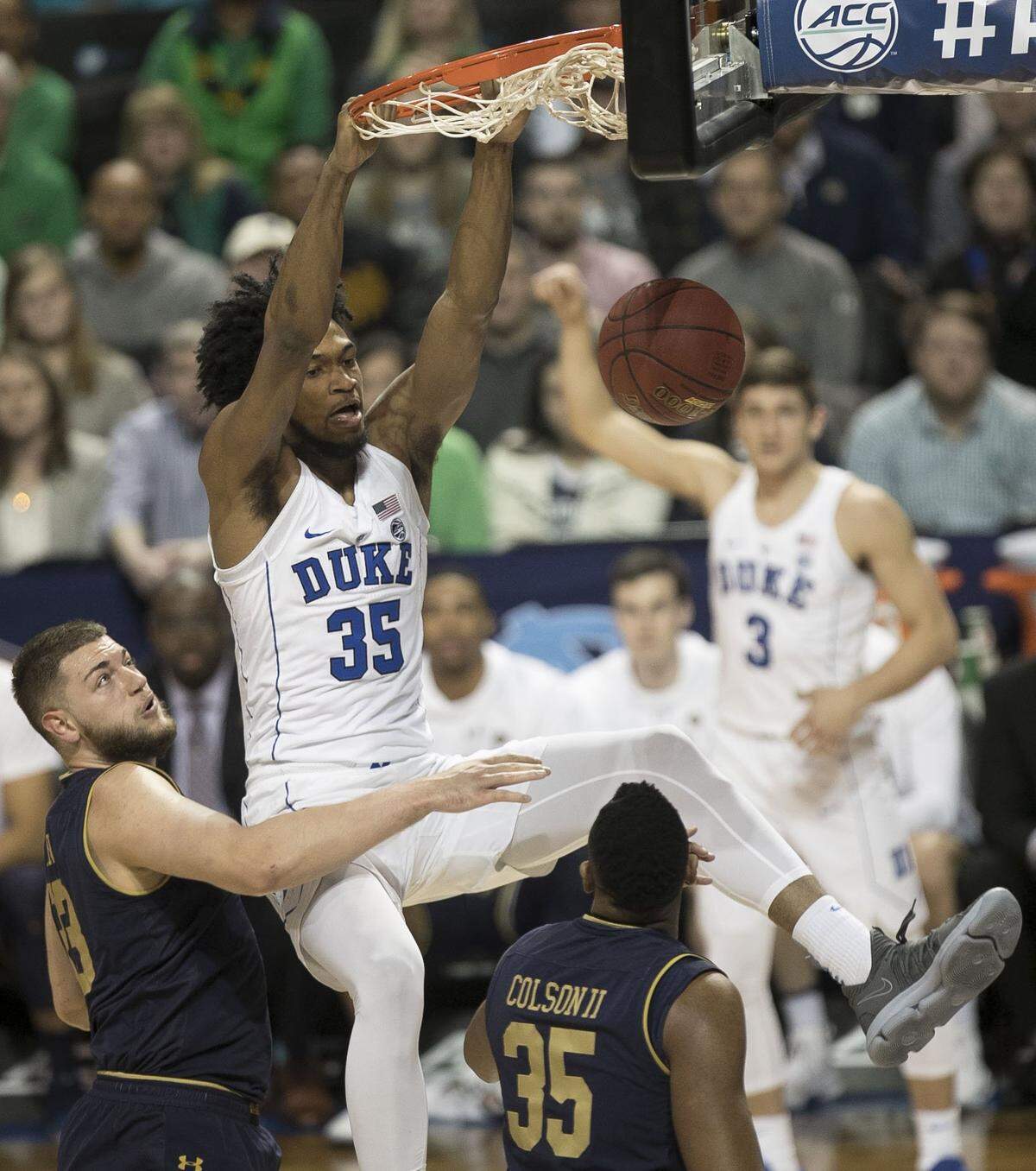 Duke's Marvin Bagley III (35) dunks over Notre Dame's Martinas Geben (23) and Bonzie Colson (35) in the first half.