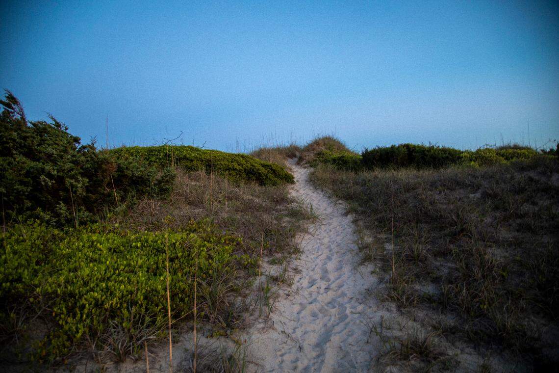 A path across a dune leads to the seashore in Ocracoke Tuesday, May 17, 2022.