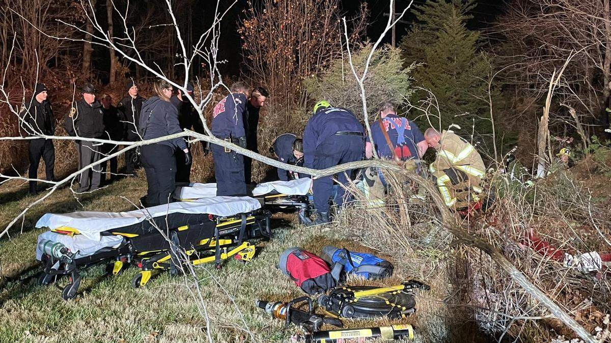 Two people spent hours trapped upside down after their car flipped over and landed on railroad tracks, Virginia firefighters say