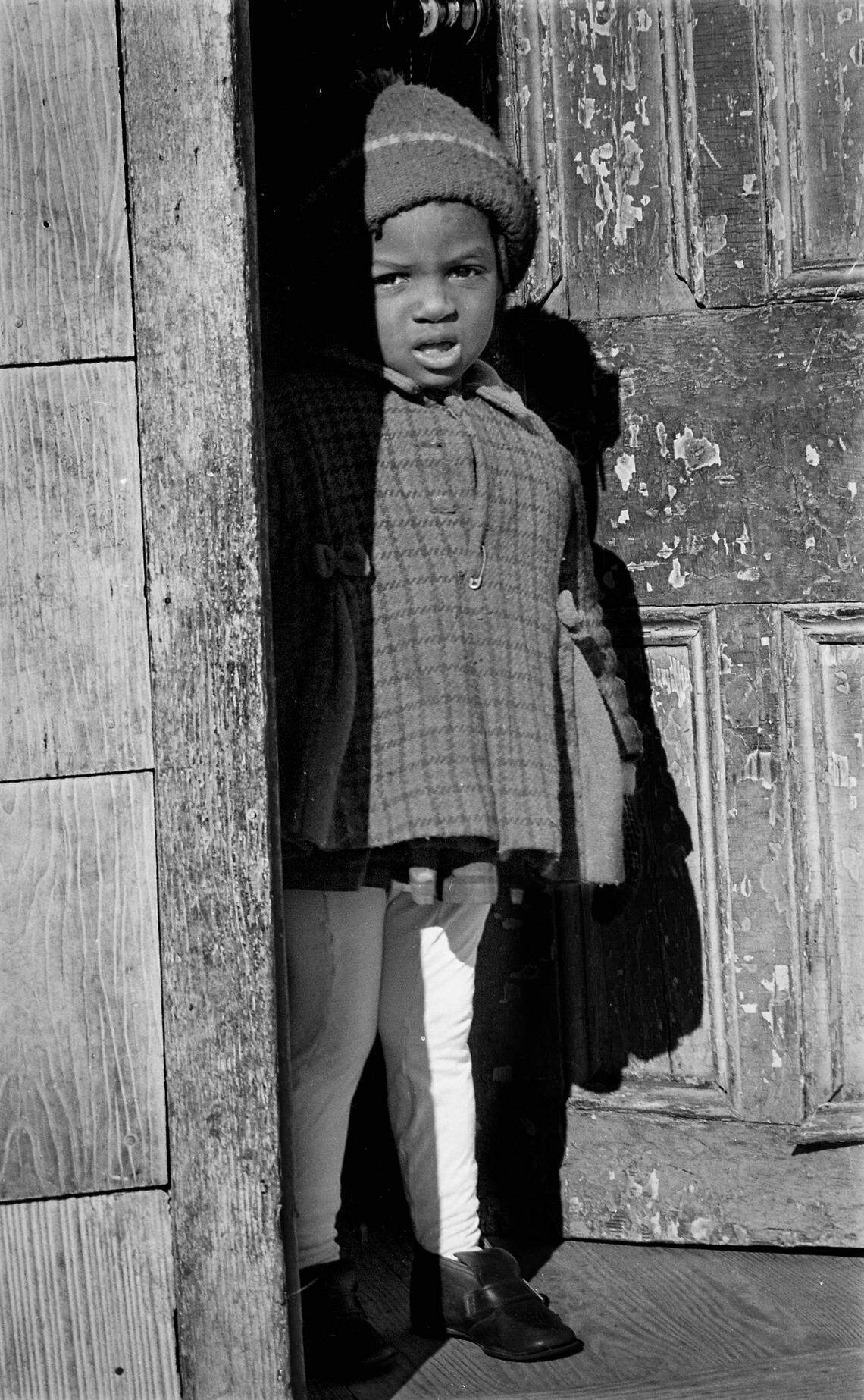 A little girl who was a member of the Bessie McDaniel family living at 208 Battle Street in the Fourth Ward/Southside neighborhood photographed January 22, 1970 for a News and Observer story on poor living conditions in the area.