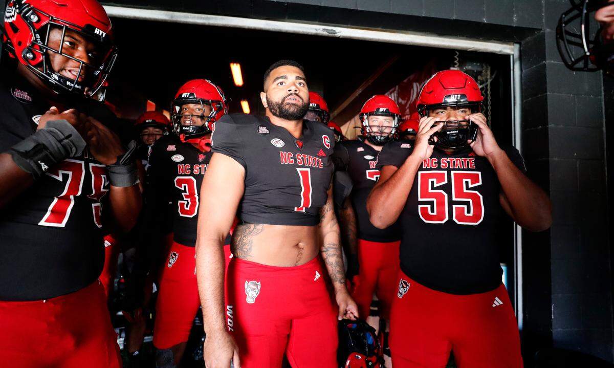 N.C. State defensive end Davin Vann (1) gets ready to head out to warm up before N.C. State’s game against Duke at Carter-Finley Stadium in Raleigh on Saturday, Nov. 9. Vann’s brother, offensive lineman Rylan Vann (55), stands to the right.