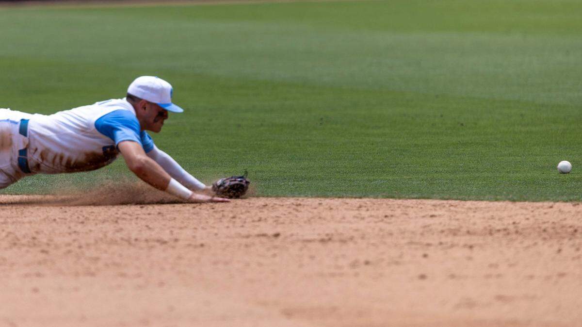A base hit by Arkansas Brady Slavens gets past North Carolina short stop Danny Serretti (1), scoring one run in the seventh inning during the first game of their Super Regional series on Saturday, June 11, 2022 at Boshamer Stadium in Chapel Hill, N.C.