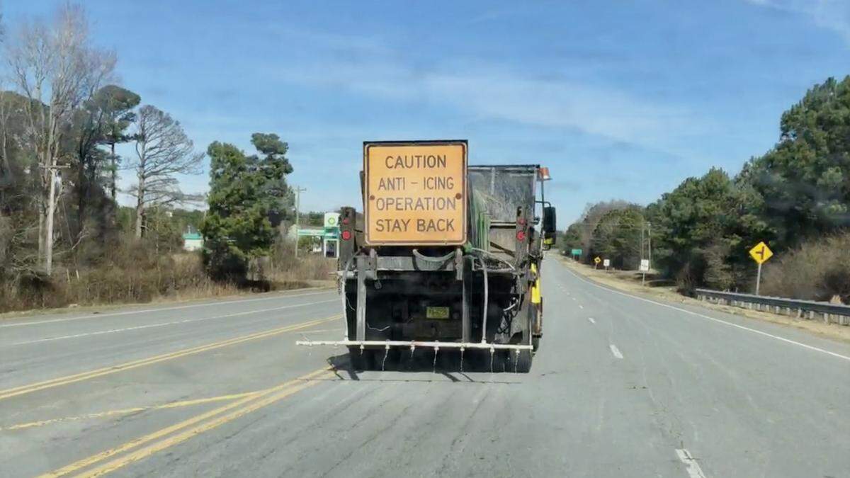 A state Department of Transportation truck spreads salt brine on N.C. 903 between Magnolia and Kenansville on Tuesday, Feb. 18, ahead of a winter storm expected to drop snow, sleet and freezing rain across much of North Carolina.