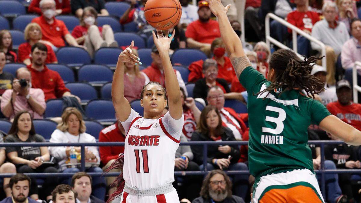 N.C. State’s Jakia Brown-Turner (11) shoots as Miami’s Destiny Harden (3) defends during the first half of N.C. State’s game against Miami in the championship of the ACC women’s basketball tournament in Greensboro, N.C., Sunday, March 6, 2022.