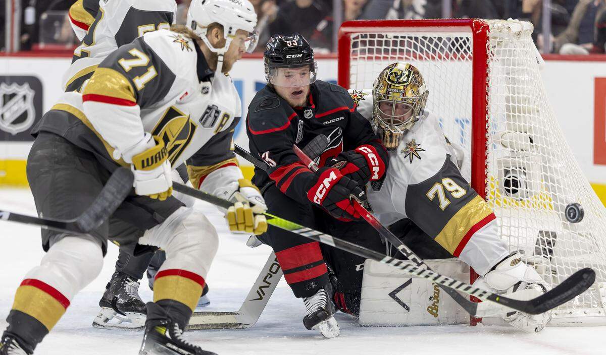 Vegas goalie Carter Hart (79) deflects a scoring attempt, as Carolina Hurricanes right wing Jackson Blake (53) tries to get his stick on the puck in the first period in Game 2 of the Stanley Cup Final, on Thursday, June 4, 2026 at Lenovo Center in Raleigh, N.C.