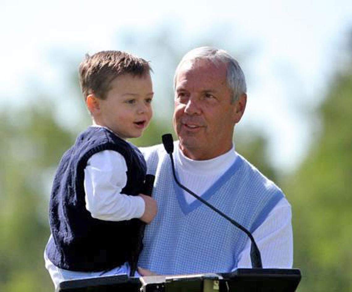 UNC basketball coach Roy Williams with a young Reece Holbrook.