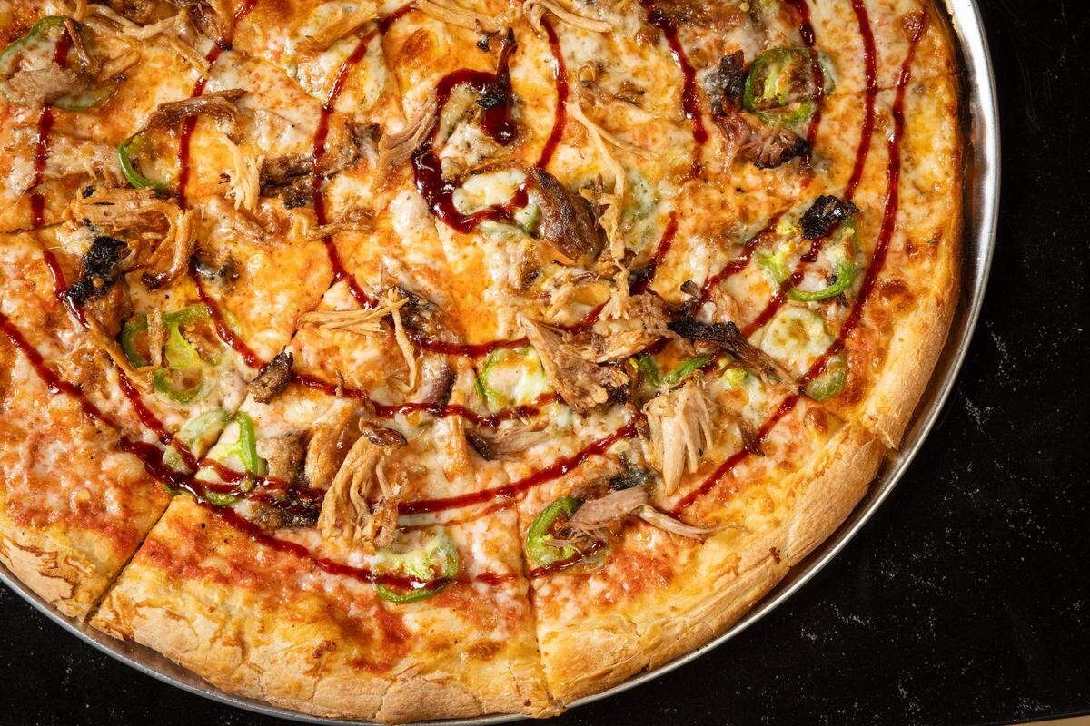 Look for The Gold Standard pizza at the new Trophy Five Points, a combination of smoked brisket, cashew cream sauce, potato, sweet and sour cabbage and golden barbecue sauce.