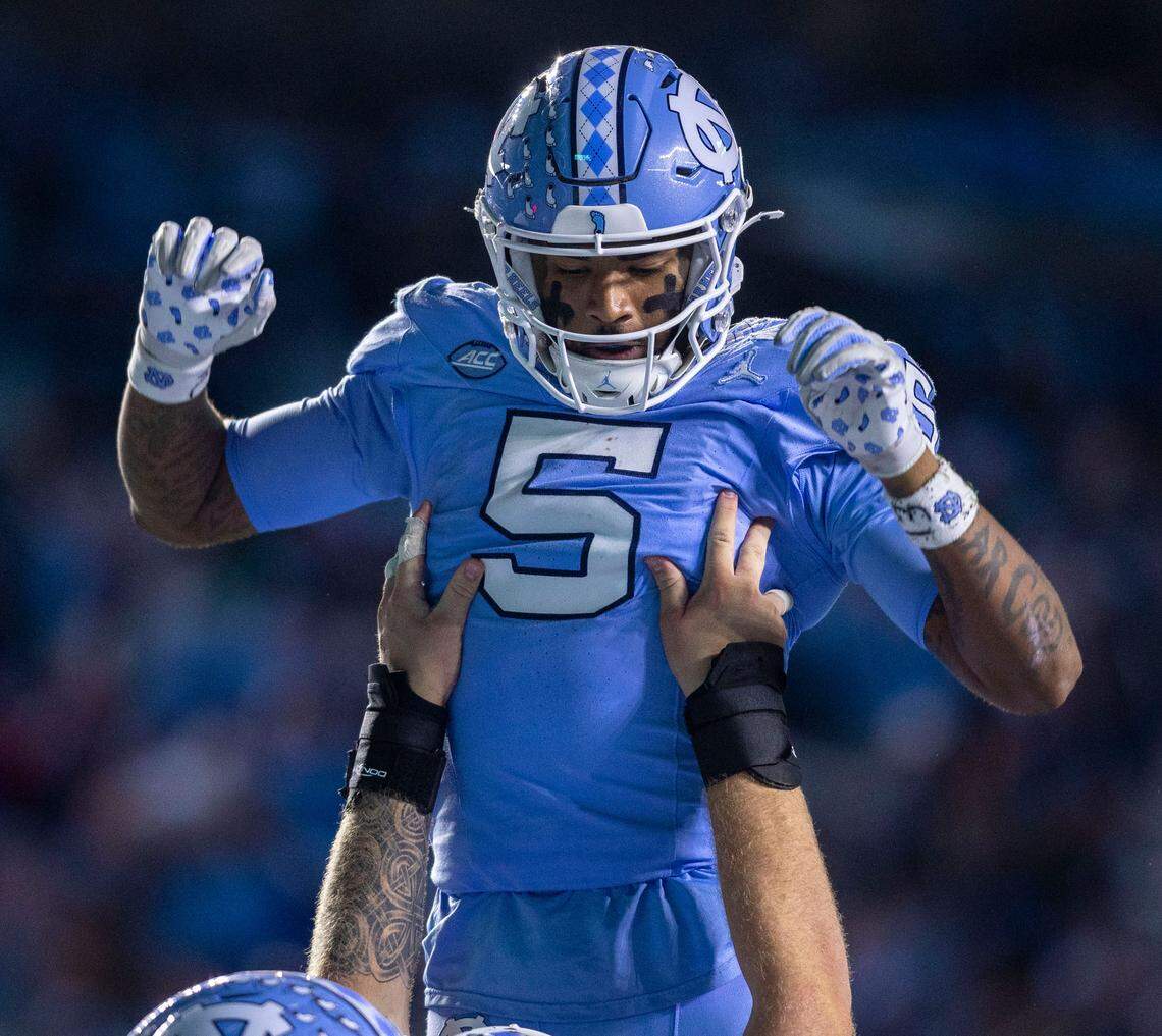North Carolina center Austin Blake lifts with wide receiver J.J. Jones (5) after a 15-yard touchdown in the third quarter against Wake Forest on Saturday, November 16, 2024 at Kenan Stadium in Chapel Hill, N.C.