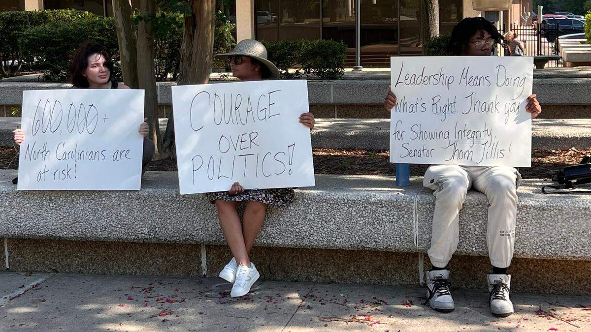 A few people gathered July 1, 2025, outside of Sen. Thom Tillis’ office in Raleigh, N.C. to thank for his opposition to the federal One Big Beautiful Bill Act. Tillis, who voted against the bill, also said he wouldn’t seek reelection in 2026.