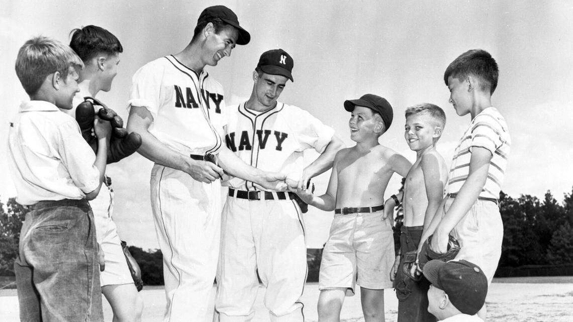 Batboys flank former Boston Red Sox sluggers Ted Williams and Johnny Pesky in Chapel Hill during World War II. One of the boys is Durham’s Carl Reynolds “Renny” Randolph, standing, second from right in long black pants.