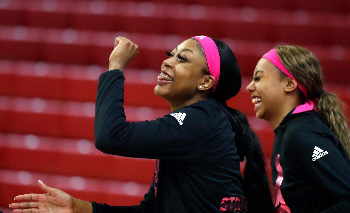 N.C. State’s Jada Boyd, left, dances while Rebecca Demeke laughs as they warm up before N.C. State’s game against UNC in the annual Play4Kay game at Reynolds Coliseum in Raleigh, N.C., Sunday, February 21, 2021.