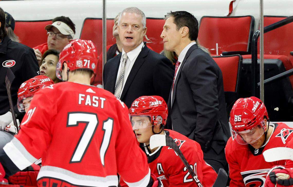 Assistant coach Jeff Daniels, left, talks with head coach Rod Brind’Amour during the first period of the Carolina Hurricanes game against the Columbus Blue Jackets at PNC Arena in Raleigh, N.C., Oct. 12, 2022.