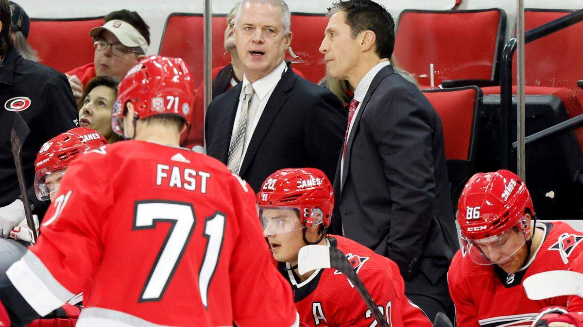 Carolina head coach Rod Brind’Amour talks with assistant coach Jeff Daniels during the first period of the Carolina Hurricanes game against the Columbus Blue Jackets at PNC Arena in Raleigh, N.C., Wednesday, Oct. 12, 2022.