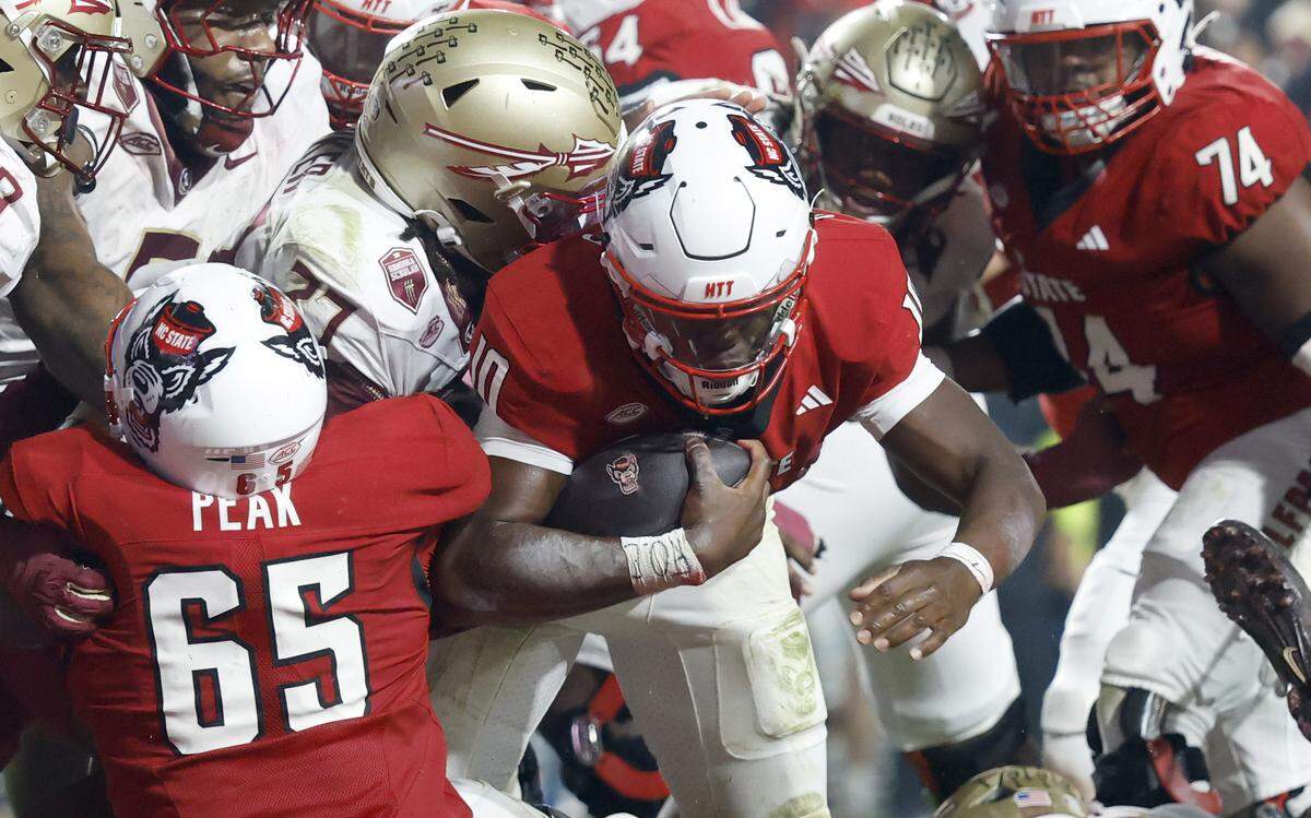 N.C. State quarterback Will Wilson (10) scores on a 1-yard run in the second half of N.C. State’s 21-11 victory over Florida State at Carter-Finley Stadium in Raleigh, N.C., Friday, Nov. 21, 2025.