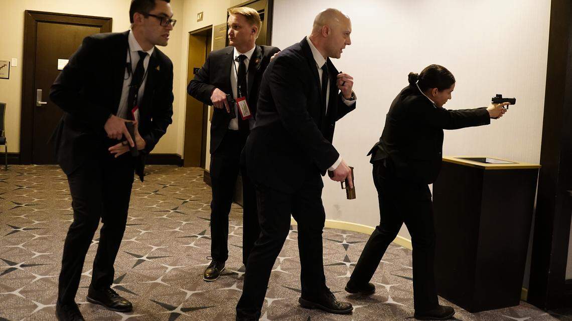 Federal agents draw their guns out after an incident at the annual White House Correspondents Association Dinner April 25, 2026 in Washington, DC. According to reports, President Donald Trump, along with other government officials, were evacuated from the Washington Hilton after what sounded like gun fire. 
