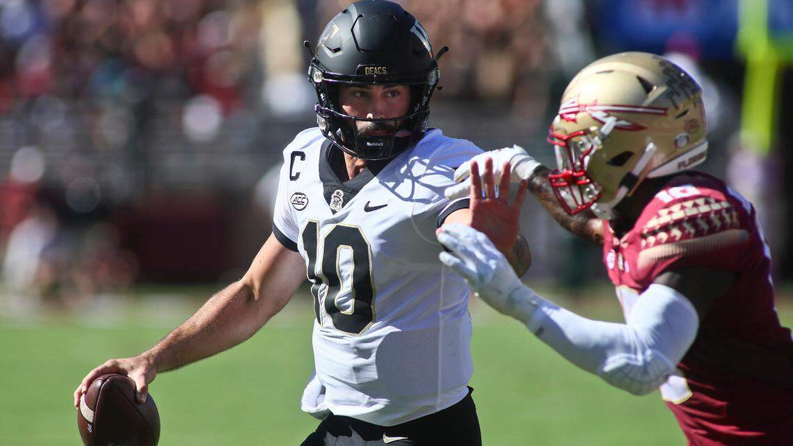 Wake Forest quarterback Sam Hartman (10) tries to stiff arm Florida State defensive back Jammie Robinson (10) in the first half of an NCAA college football game against Florida State Saturday, Oct. 1, 2022, in Tallahassee, Fla. (AP Photo/Phil Sears)