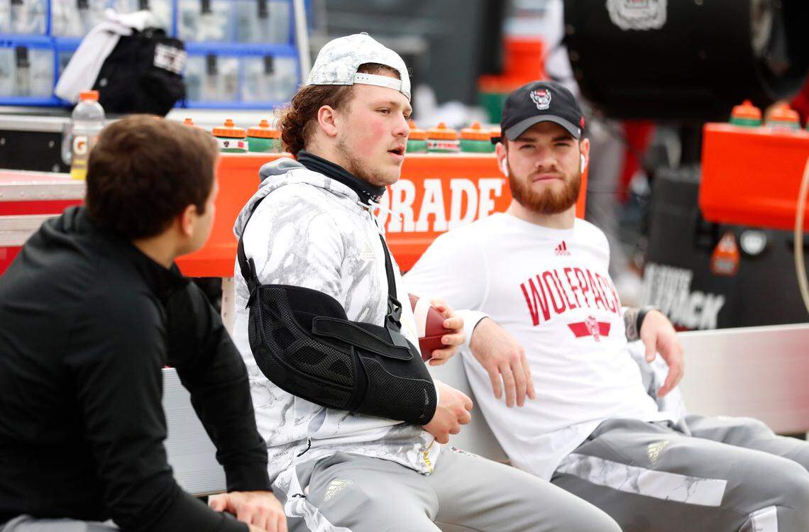 N.C. State linebacker Drake Thomas and quarterback Devin Leary sit on the bench before N.C. State’s game against Kentucky in the Gator Bowl at TIAA Bank Field in Jacksonville, Fla., Saturday, January 2, 2021.
