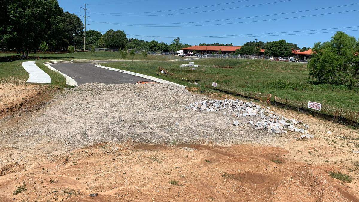The planned new driveway from the State Farmers Market to Lake Wheeler Road in Raleigh ends in piles of gravel for now.