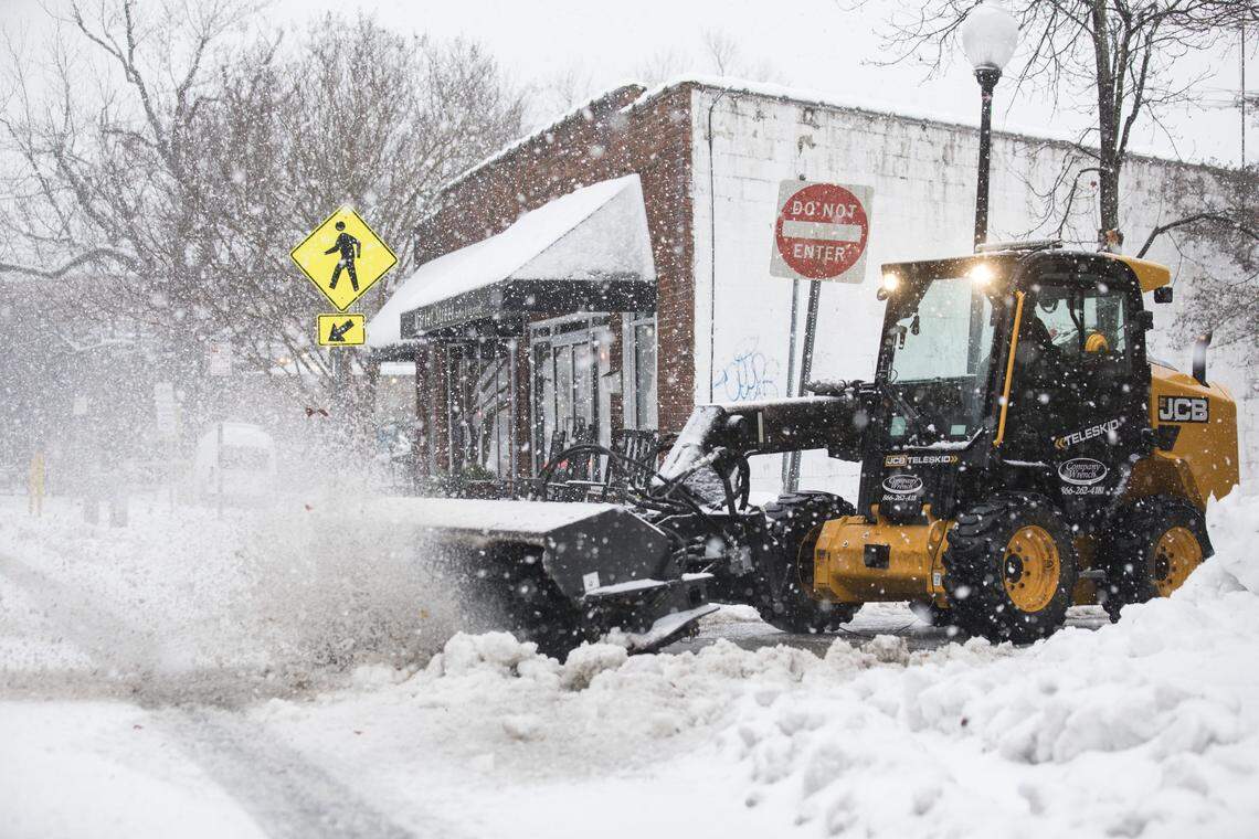 A utility vehicle clears the driveway to the Carrboro police station on Monday morning, Dec. 10, 2018.