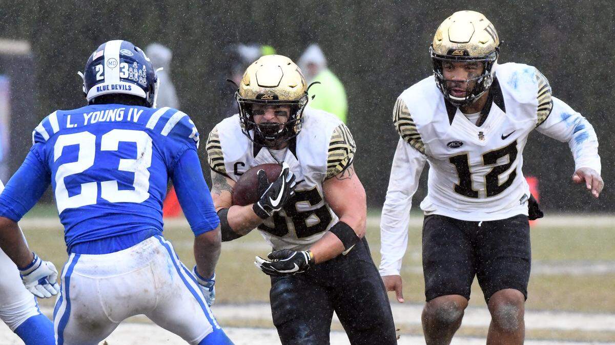 Duke safety Lummie Young IV (23) looks to stop Wake Forest running back Cade Carney (36) as quarterback Jamie Newman (12) hands off the ball in the second quarter at Wallace Wade Stadium, Saturday, Nov. 24, 2018 in Durham, N.C.