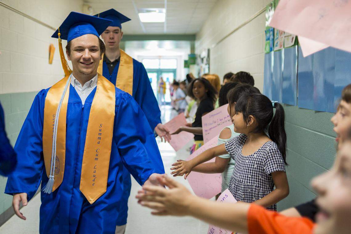 Conner Kocher, a graduating senior, walks through the halls of his former elementary school on June 5, 2019 at Timber Drive Elementary School in Garner, NC. Graduating seniors who attended the elementary school in Garner returned for a student clap-out in which they were celebrated for their achievement.