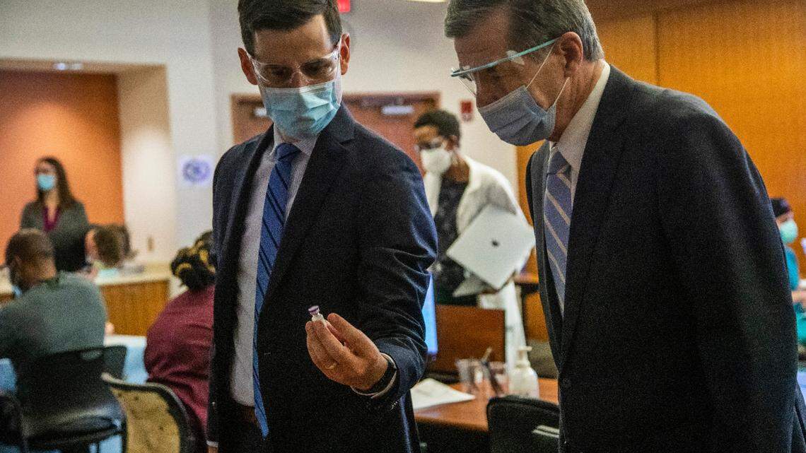 Dr. Dan Schenkat shows Gov. Roy Cooper a vial containing Covid-19 vaccine at UNC Health in Chapel Hill, NC Thursday, Dec. 17, 2020 where frontline healthcare workers are among some of the first recipients of the Pfizer COVID-19 vaccine.