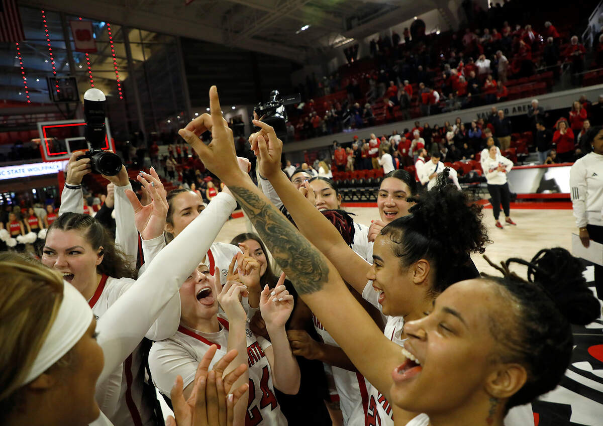 N.C. State celebrates at center court following its 72-57 win over Duke on Sunday, Jan. 21, 2024, at Reynolds Coliseum in Raleigh, N.C.