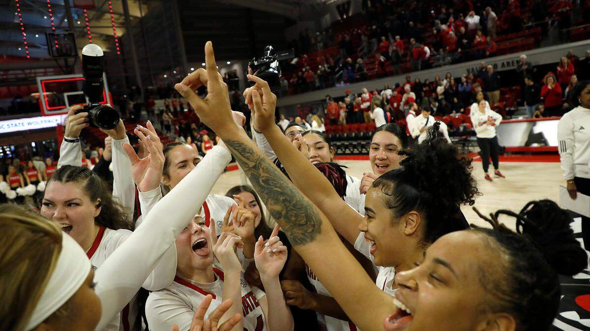 N.C. State celebrates at center court following its 72-57 win over Duke on Sunday, Jan. 21, 2024, at Reynolds Coliseum in Raleigh, N.C.
