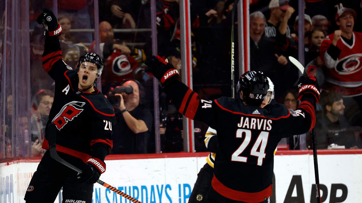 Carolina Hurricanes forward Sebastian Aho (20) celebrates with teammate Seth Jarvis (24) after scoring during the first period of an NHL hockey game against the Boston Bruins in Raleigh, N.C., Sunday, Jan. 29, 2023.