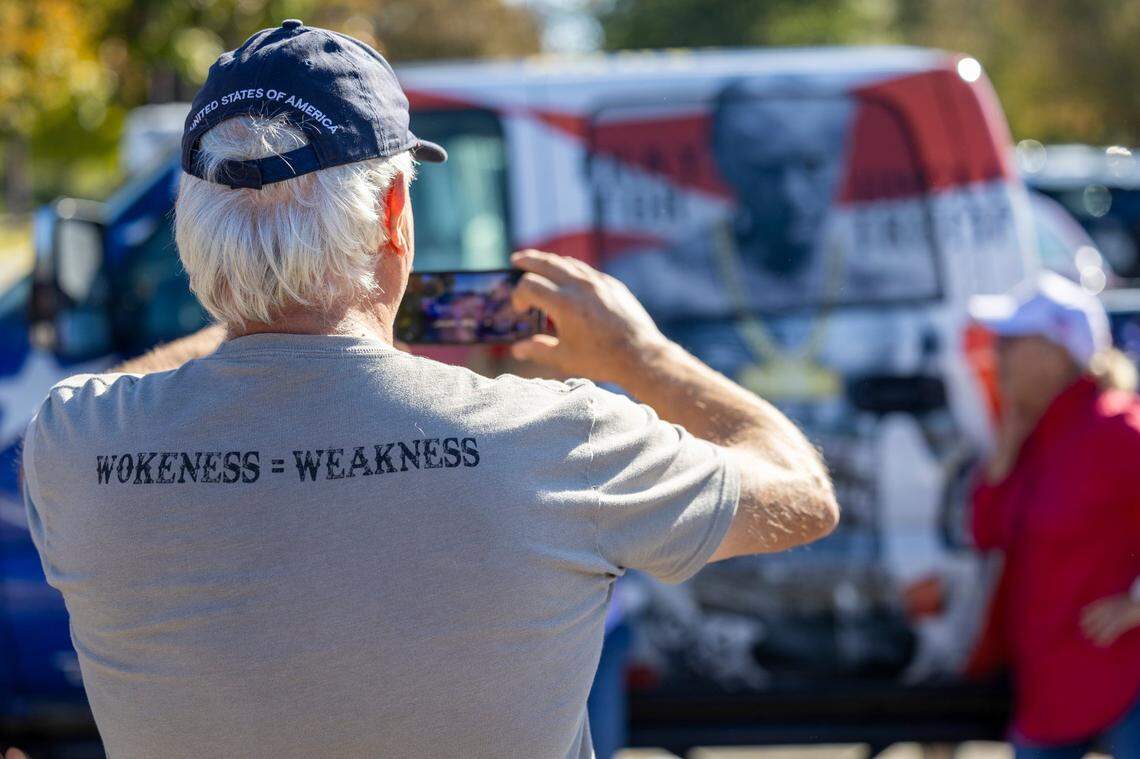 A supporter of former President Donald Trump takes a photograph on his phone outside Minges Coliseum in Greenville prior to a rally on Monday, Oct. 21, 2024. With two weeks until Election Day, Trump went on a three-city tour, in which Trump will also see the destruction caused by Hurricane Helene in Asheville and speak at a faith conference in Concord.