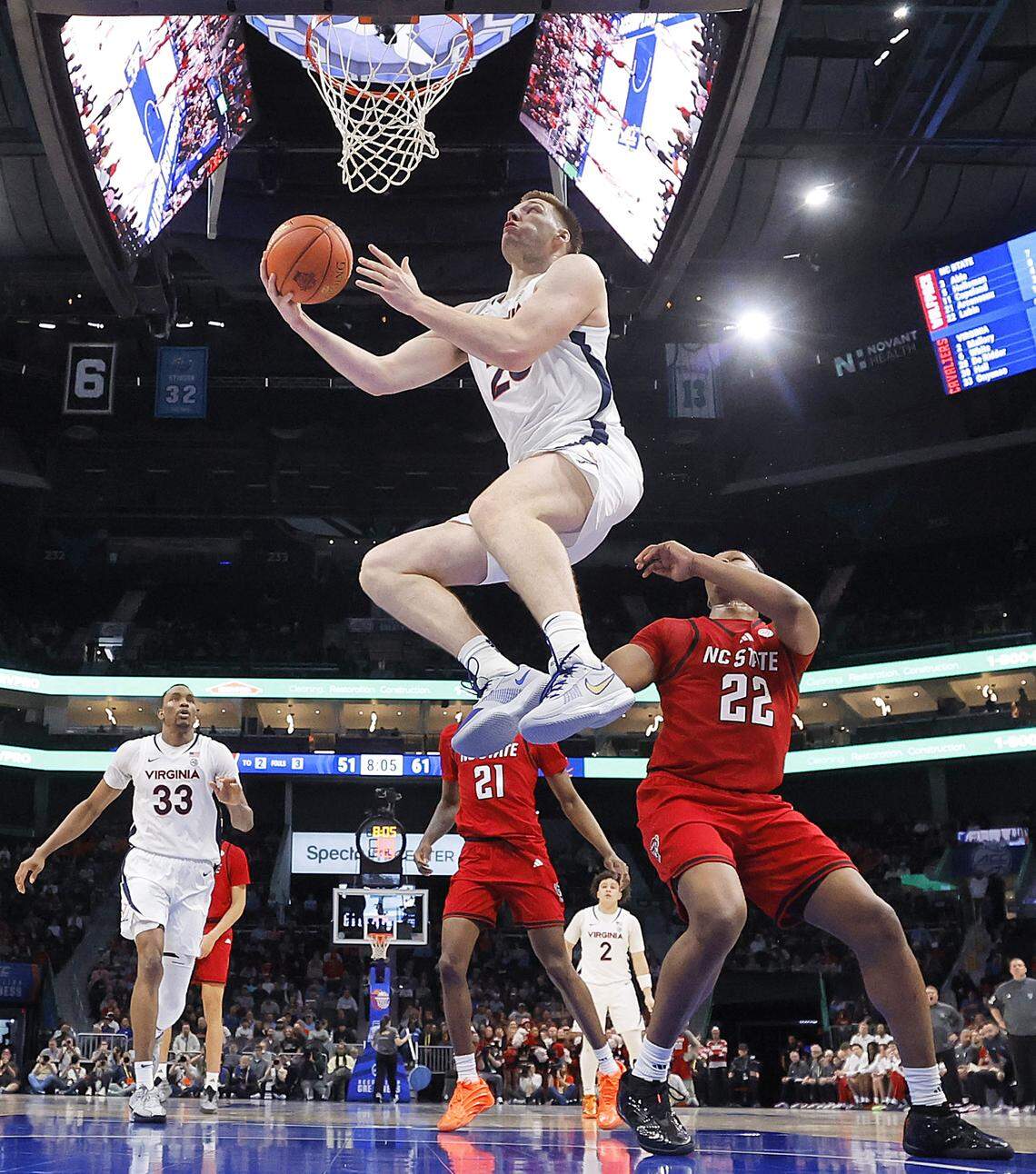 Virginia's Thijs de Ridder drives to the basket past N.C. State's Ven-Allen Lubin during the second half of the Wolfpack’s 81-74 loss in the ACC Tournament quarterfinals on Thursday, March 12, 2026, at the Spectrum Center in Charlotte, N.C. 