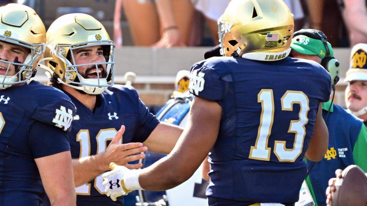 Notre Dame Fighting Irish quarterback Sam Hartman (10) celebrates with tight end Holden Staes (13) after a touchdown in the second quarter against the Tennessee State Tigers at Notre Dame Stadium.