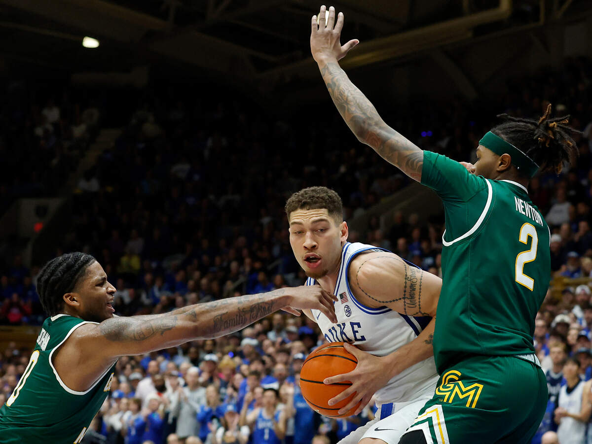 Duke’s Mason Gillis drives between George Mason’s K.D. Johnson and Woody Newton during the first half of the Blue Devils’ 68-47 win on Tuesday, Dec. 17, 2024, at Cameron Indoor Stadium in Durham, N.C.