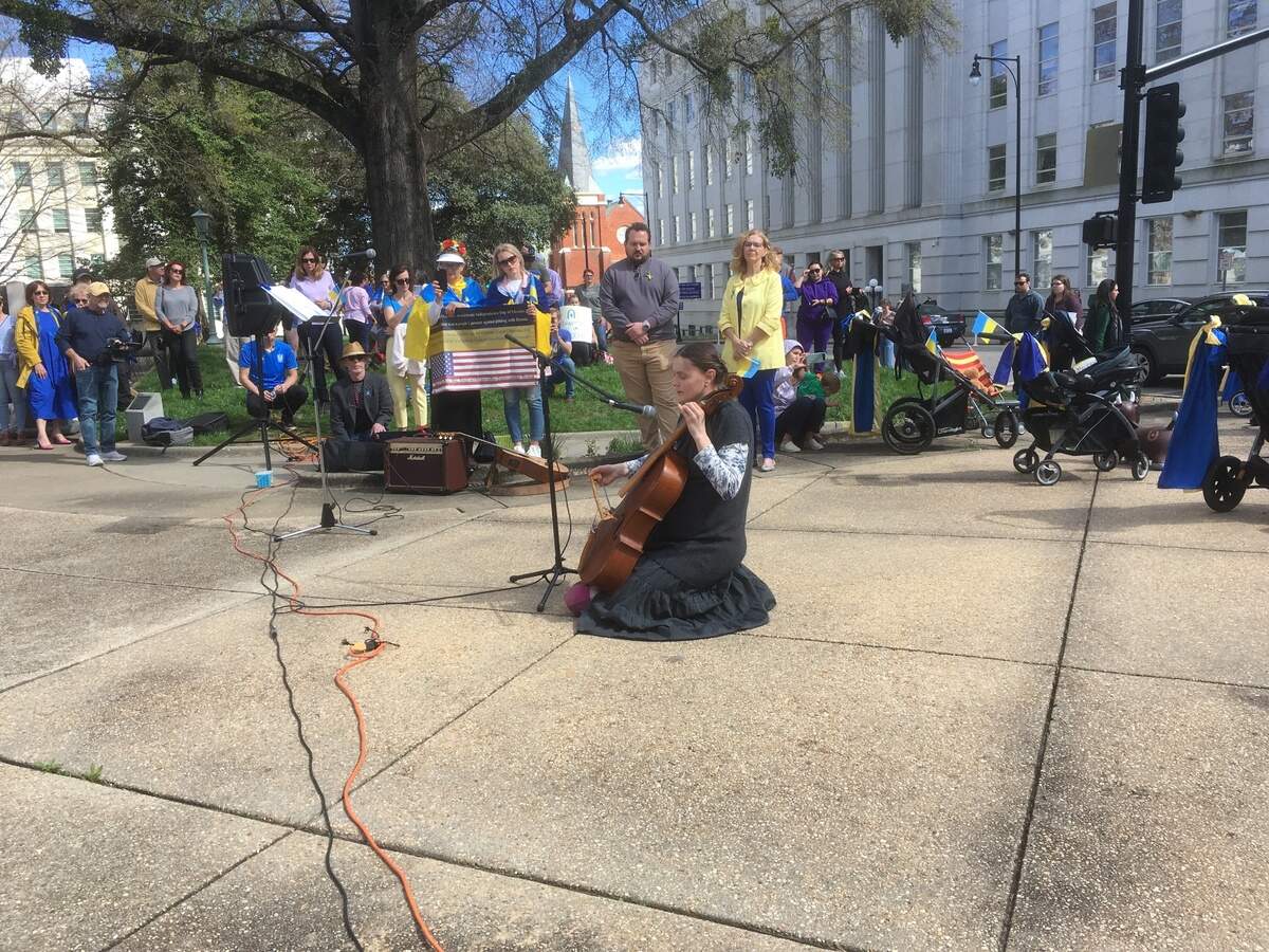 Marila Fedynskyj performs at a Stand with Ukraine rally at the state Capitol Sunday. She and her four children fled the war-torn country. Her husband, Jurij, a Raleigh native and also a musician, remains there and performs for those staying in bomb shelters.