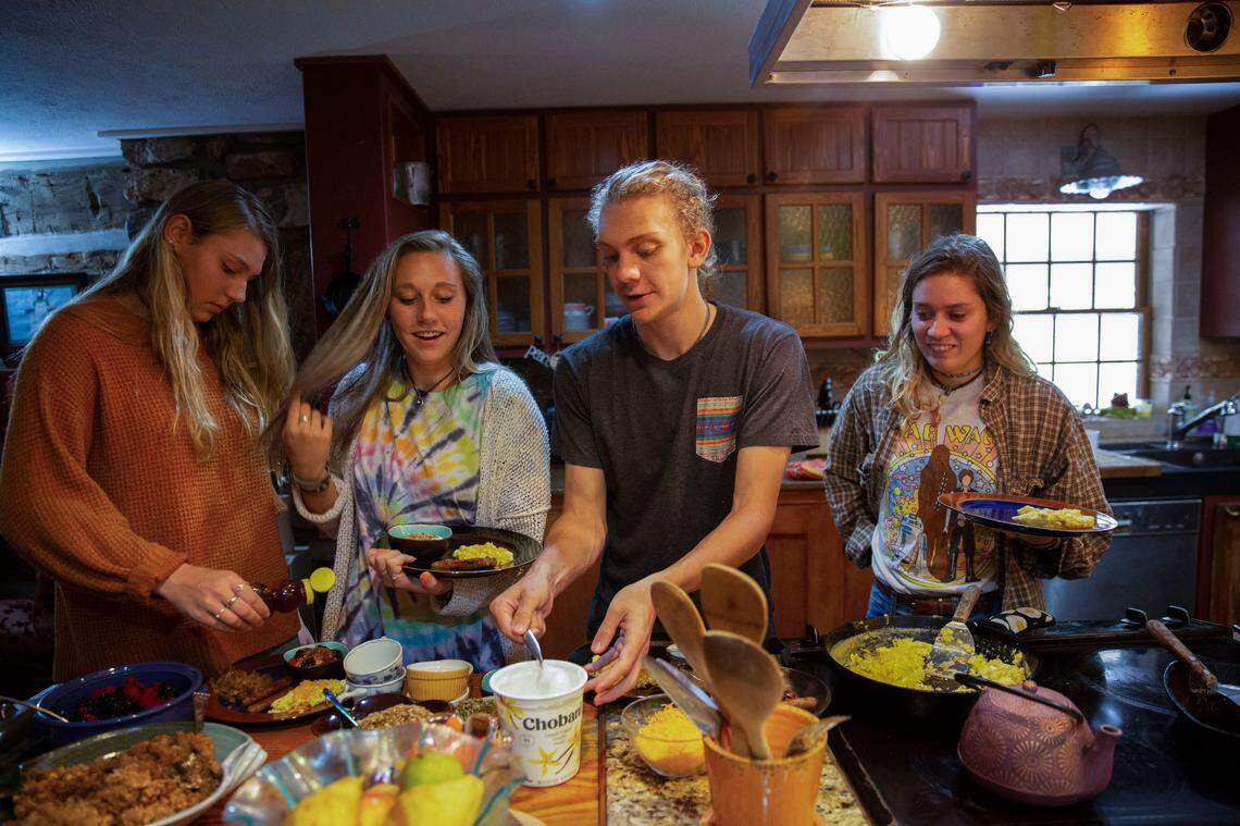 Among his friends and family, Riley Howell was known for his appetite. Big meals became a way to honor and remember him. Here, his siblings Juliet, Iris, and Teddy, and his longtime girlfriend, Lauren Westmoreland, fill their plates for breakfast on Sunday October 20, 2019. Jessica Koscielniak / jkoscielniak@mcclatchy.com