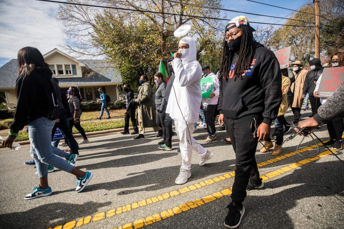 Demonstrators participating in the march to the polls in Graham chant the names of people killed by police as they march towards the Alamance County Historic Courthouse on Oct. 31, 2020.