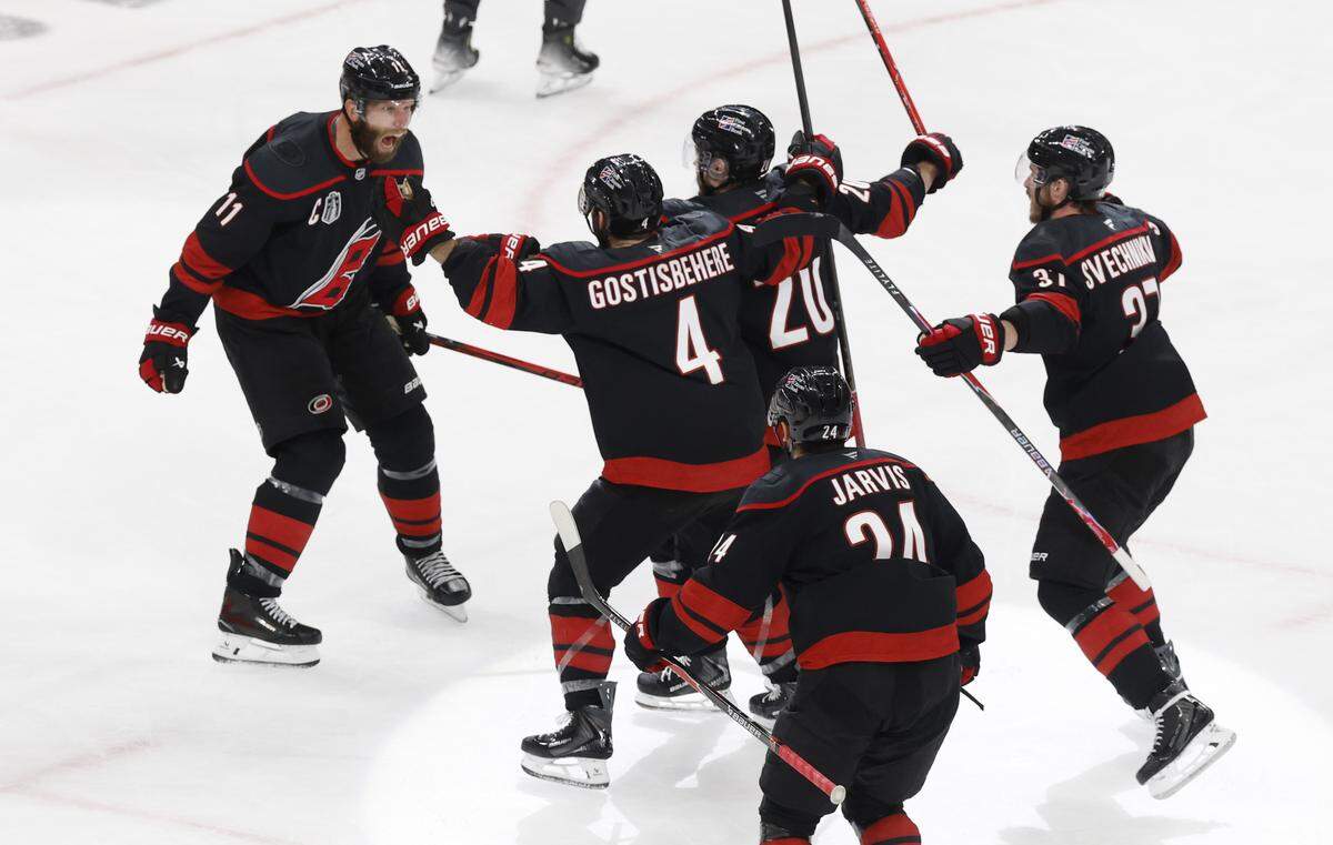 Players celebrate with Carolina's Jordan Staal (11) after he scored in the third period of the Hurricanes’ game against the Golden Knights in the second game of the Stanley Cup Final at the Lenovo Center in Raleigh, N.C., Thursday, June 4, 2026.