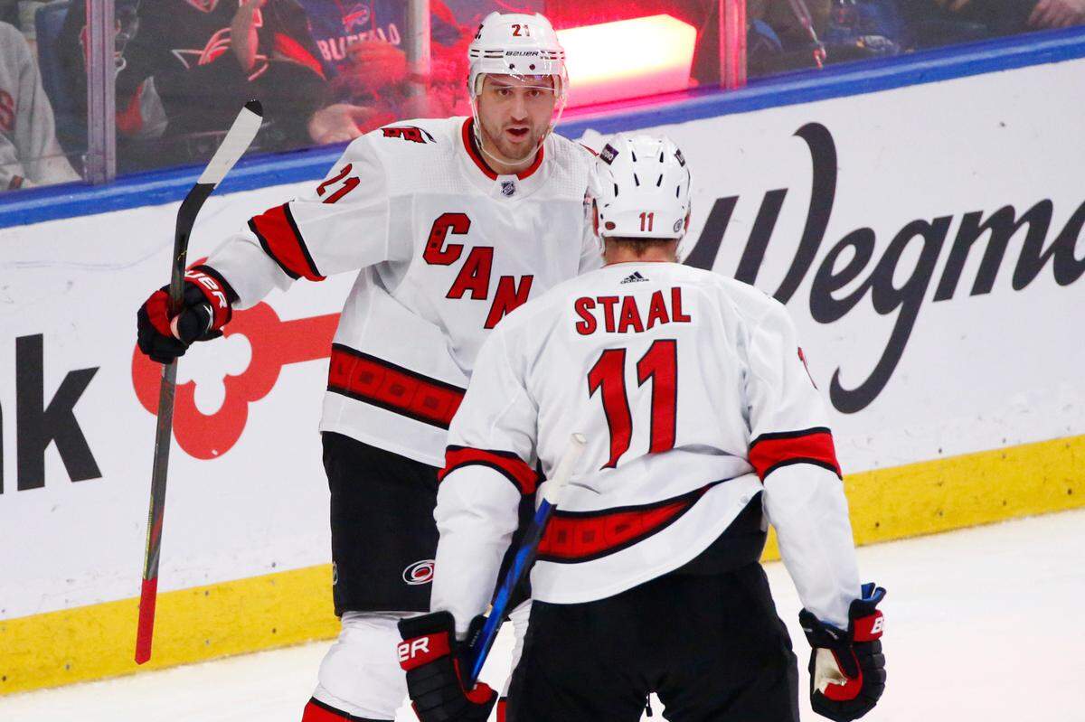 Carolina Hurricanes right wing Nino Niederreiter (21) celebrates his goal with center Jordan Staal (11) during the third period of the team’s NHL hockey game against the Buffalo Sabres, Tuesday, April 5, 2022, in Buffalo, N.Y. (AP Photo/Jeffrey T. Barnes)