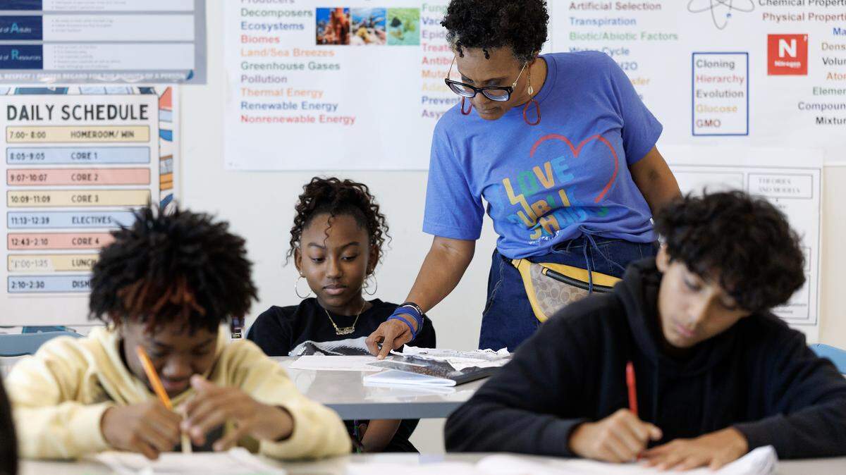 Principal Bonnie Mwanda assists seventh-grade student Kaydence Hasty during a science class on Friday, Aug. 15, 2025, at Neuse River Middle School in Raleigh, N.C.