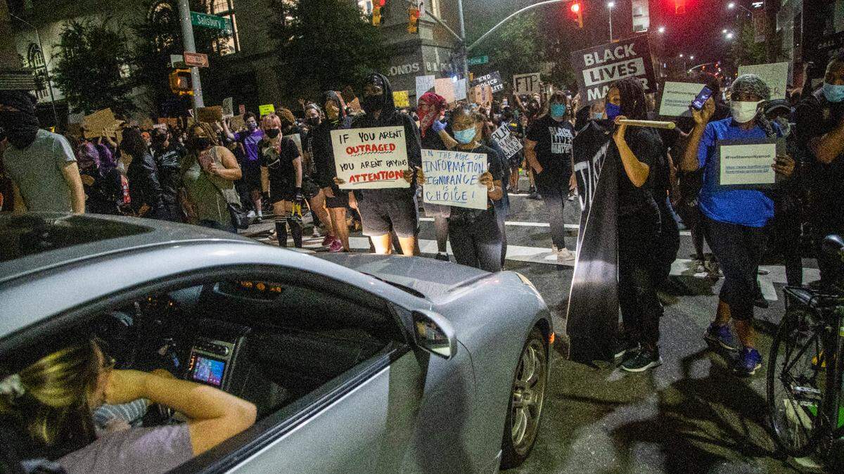 Demonstrators briefly block traffic on South Saunders Street during a march and protest against systemic racism in downtown Raleigh Friday, Aug. 28, 2020 after the police shooting of Jacob Blake in Kenosha, WI.