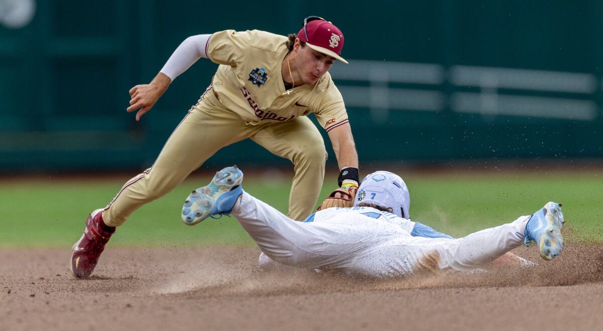 Florida State short stop Alex Lodise (1) tags North Carolina outfielder Vance Honeycutt (7) out stealing second base in the seventh inning during game nine of the College World Series on Tuesday, June 18, 2024 at Charles Schwab Field in Omaha, Nebraska.