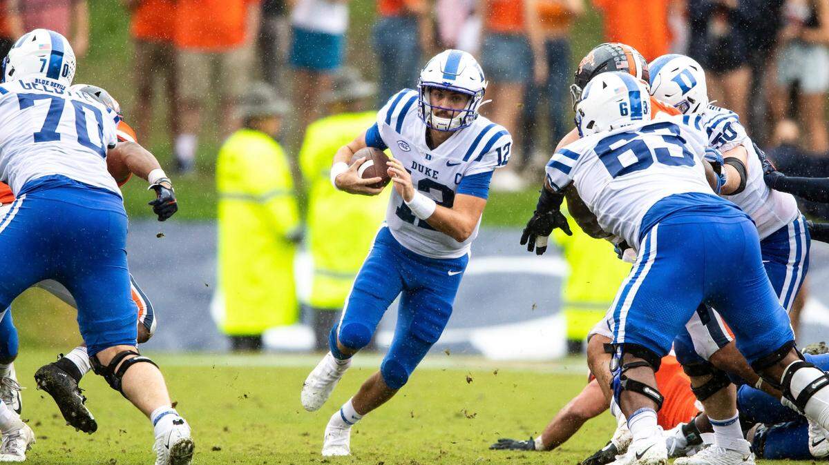 Duke Blue Devils quarterback Gunnar Holmberg (12) looks for a hole to run through during the second quarter of an NCAA football game at Scott Stadium on Saturday October 16, 2021 in Charlottesville, Va. (AP Photo/Mike Caudill)