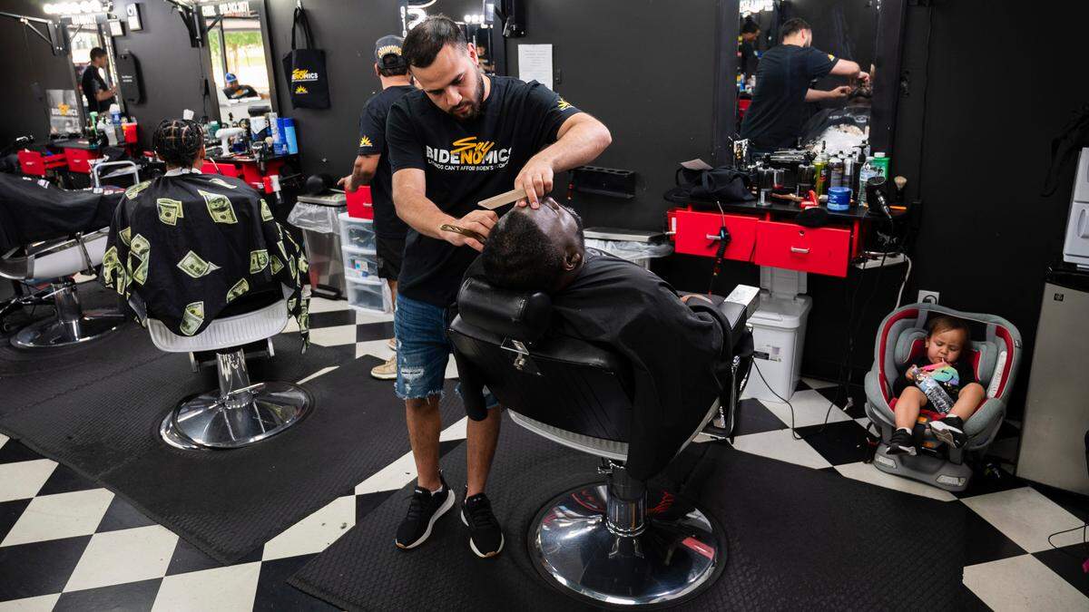Kareem Pierre has his hair cut by Luis Enrique at Dr. Unisex Salon in Raleigh during an event aimed at connecting with the community to discus Bidenomics and offering free haircuts on Thursday, June 13, 2024.