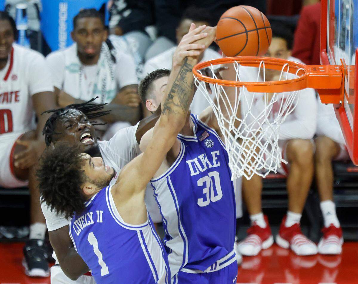 Duke’s Dereck Lively II and Kyle Filipowski battle for a rebound with N.C. State’s Ebenezer Dowuona during the second half of a men’s basketball game at PNC Arena on Wednesday, Jan. 4, 2023, in Raleigh, N.C.
