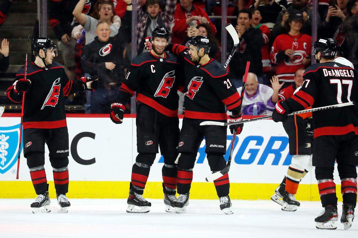 Carolina Hurricanes’ Jordan Staal, center, is congratulated on his goal by teammate Nino Niederreiter (21) and Jesper Fast, left, during the third period of an NHL hockey game Anaheim Ducks in Raleigh, N.C., Sunday, April 10, 2022. (AP Photo/Karl B DeBlaker)
