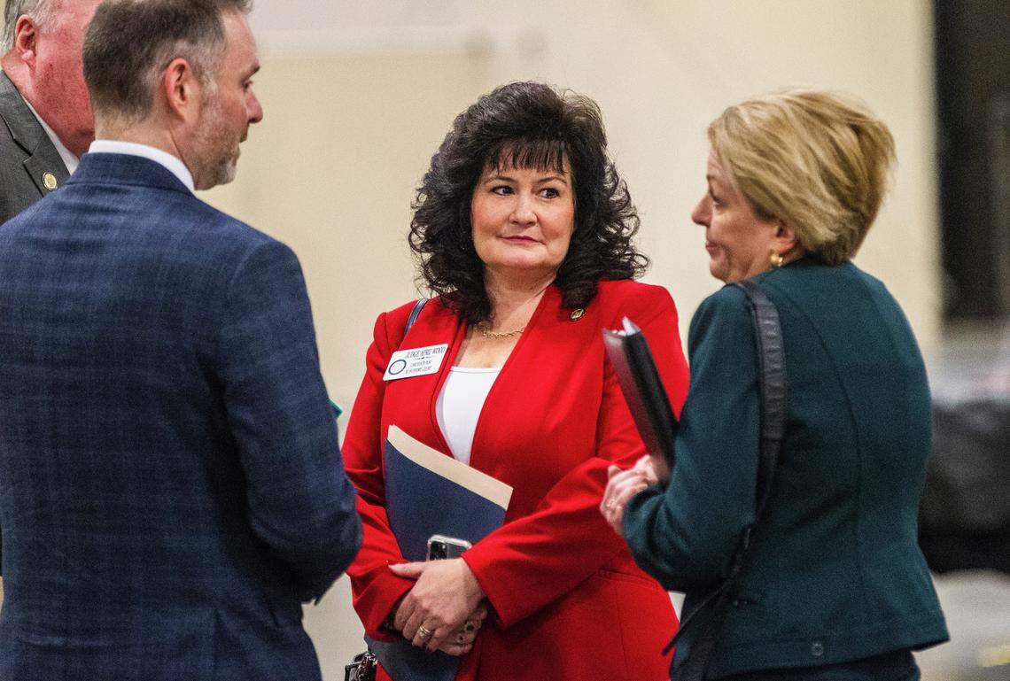 North Carolina Court of Appeals Judge April Wood, center, talks with other people after registering to run for the NC Supreme Court at the NC State Fairgrounds Monday, Dec. 6, 2021.