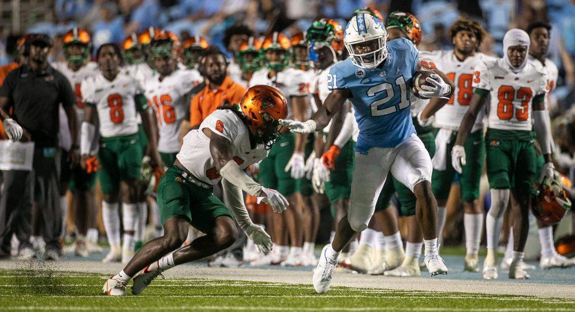 North Carolinas Elijah Green (21) breaks away from Florida A&Ms Timothy Williams Jr. (6) for a 46-yard gain in the fourth quarter on Saturday, August 27, 2022 at Kenan Stadium in Chapel Hill, N.C.