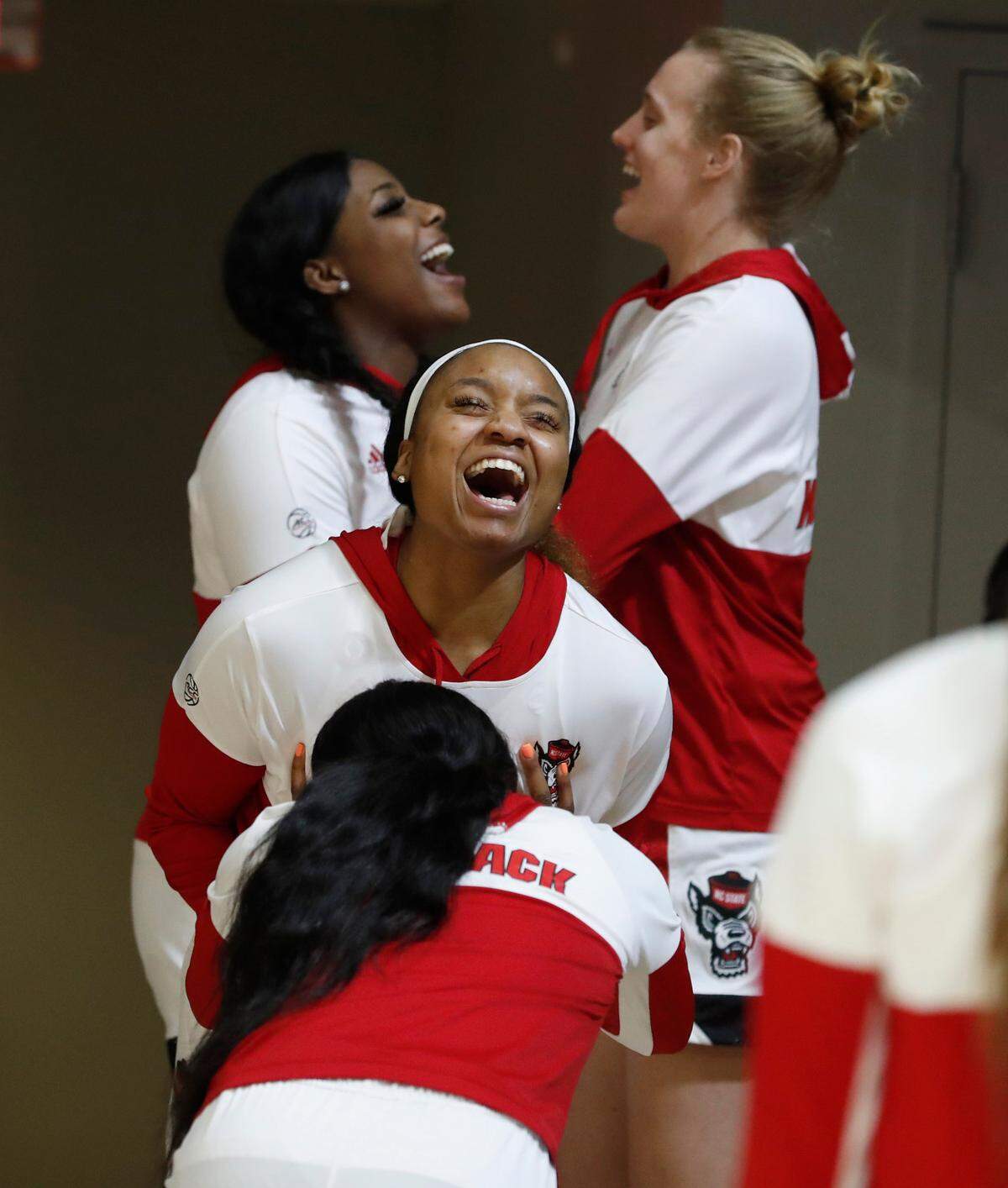 N.C. State’s Jada Boyd, back to camera and Kayla Jones laugh before taking the court before N.C. State’s game against Pittsburgh at Reynolds Coliseum in Raleigh, N.C., Thursday, February 25, 2021.