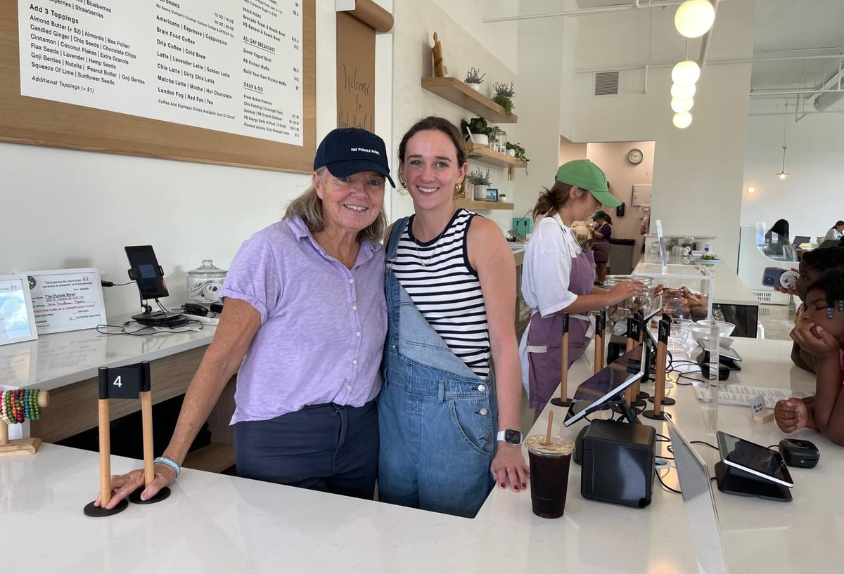 Purple Bowl co-owner Paula Gilland, at left, and General Manager McClaren Hopper pose for a photo at the restaurant’s front counter on Wednesday, Oct. 2, 2024. The newly renovated space features a separate coffee bar and a 2,000-square-foot patio.